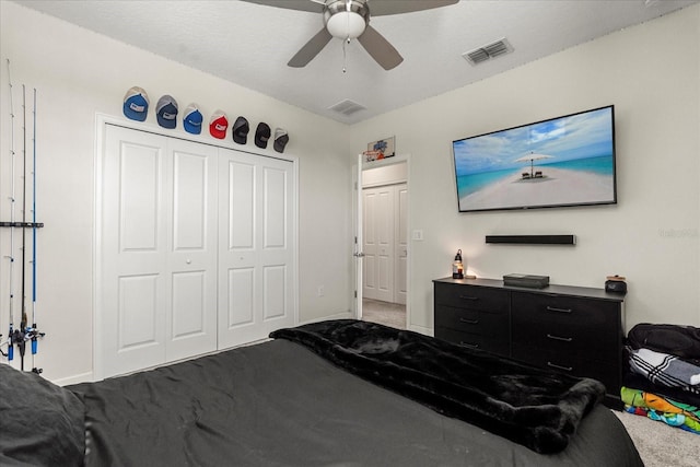 carpeted bedroom featuring baseboards, visible vents, and a closet
