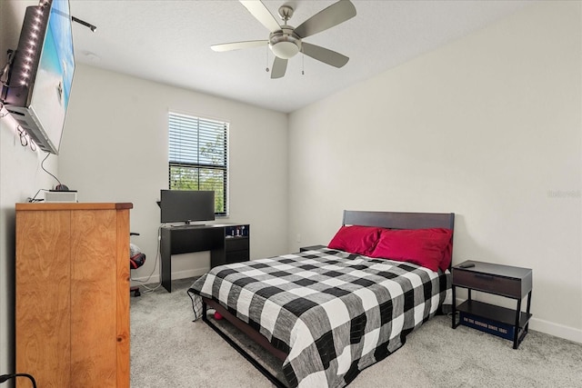 bedroom with baseboards, ceiling fan, and carpet