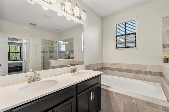 bathroom with a sink, a stall shower, a garden tub, and visible vents