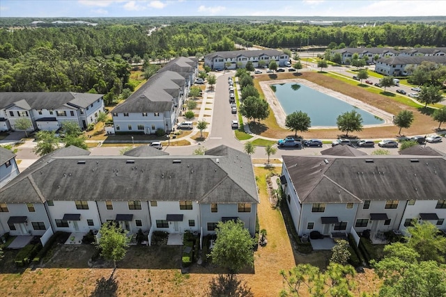 aerial view featuring a water view, a residential view, and a forest view
