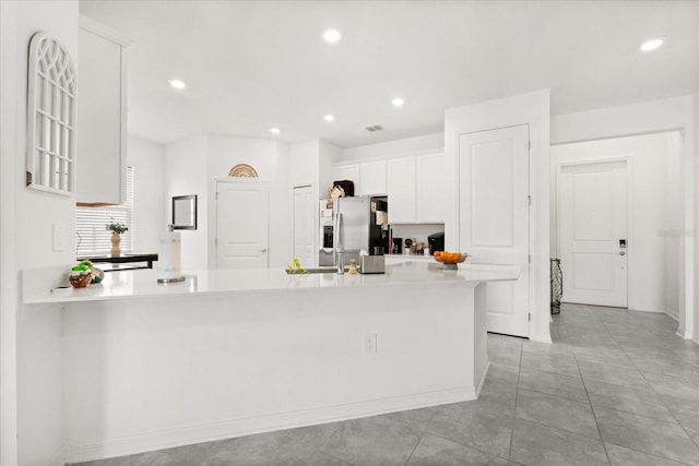 2156 Merrybells Dr, Kissimmee, FL 34746 - kitchen featuring stainless steel fridge, white cabinetry, light countertops, recessed lighting, and baseboards