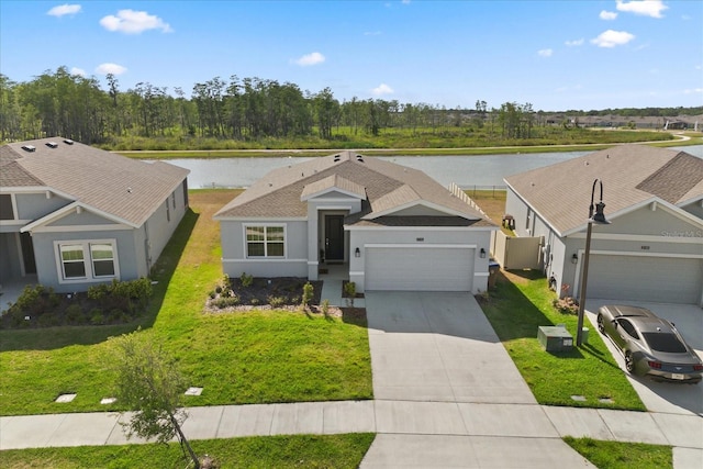 2156 Merrybells Dr, Kissimmee, FL 34746 - view of front of home with a water view, a garage, driveway, and stucco siding