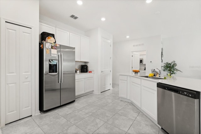 2156 Merrybells Dr, Kissimmee, FL 34746 - kitchen featuring appliances with stainless steel finishes, a sink, white cabinets, recessed lighting, and light countertops