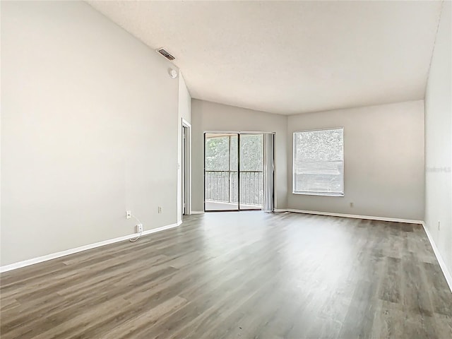 unfurnished room with baseboards and wood finished floors