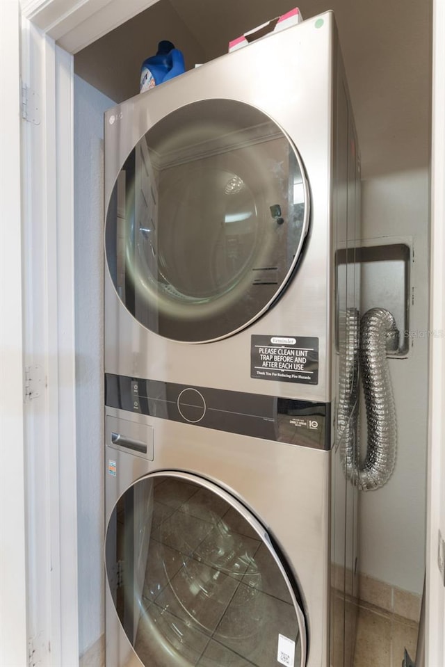 clothes washing area featuring laundry area and stacked washer and dryer