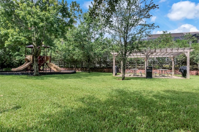 view of yard with a pergola and playground community