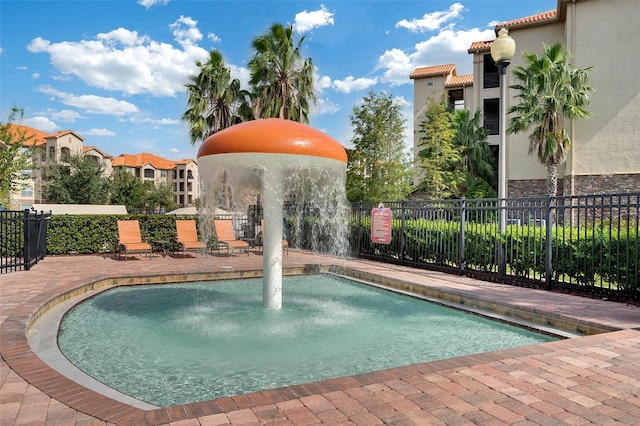 view of pool featuring a patio, fence, and a pool