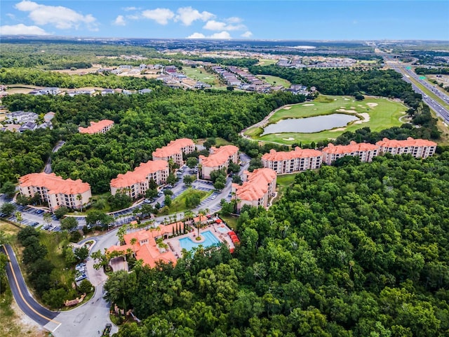 birds eye view of property with a water view and golf course view