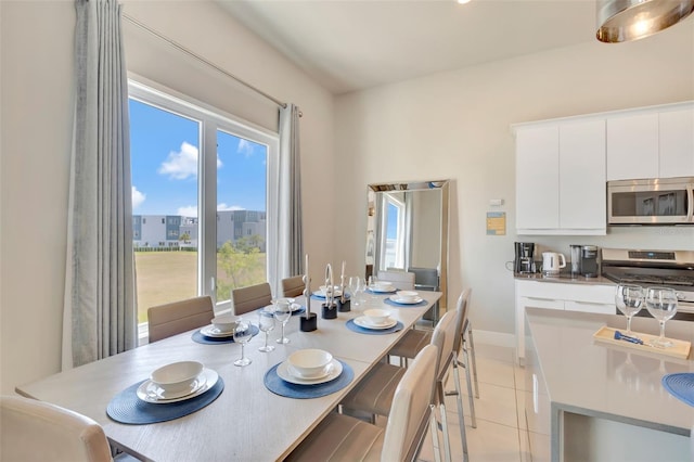 7740 Sandy Ridge Dr Unit 236, Reunion, FL 34747 - dining area featuring light tile patterned floors and baseboards