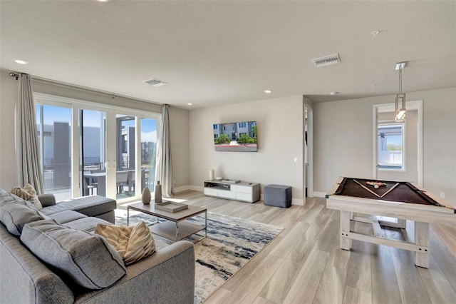 7740 Sandy Ridge Dr Unit 236, Reunion, FL 34747 - living area featuring light wood-style flooring, plenty of natural light, baseboards, and visible vents