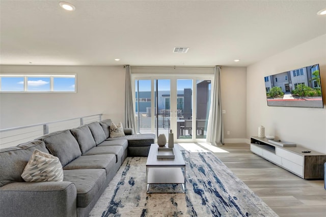 7740 Sandy Ridge Dr Unit 236, Reunion, FL 34747 - living room featuring french doors, light wood-type flooring, visible vents, baseboards, and recessed lighting