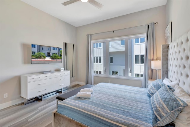 7740 Sandy Ridge Dr Unit 236, Reunion, FL 34747 - bedroom with baseboards, a ceiling fan, and wood finished floors