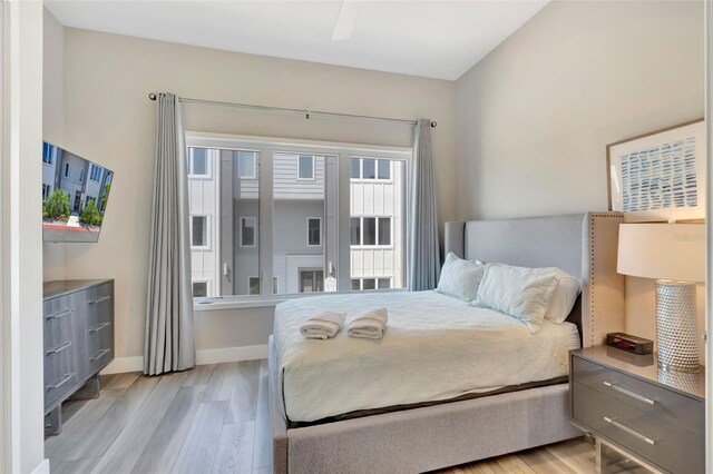 7740 Sandy Ridge Dr Unit 236, Reunion, FL 34747 - bedroom featuring light wood-type flooring and baseboards