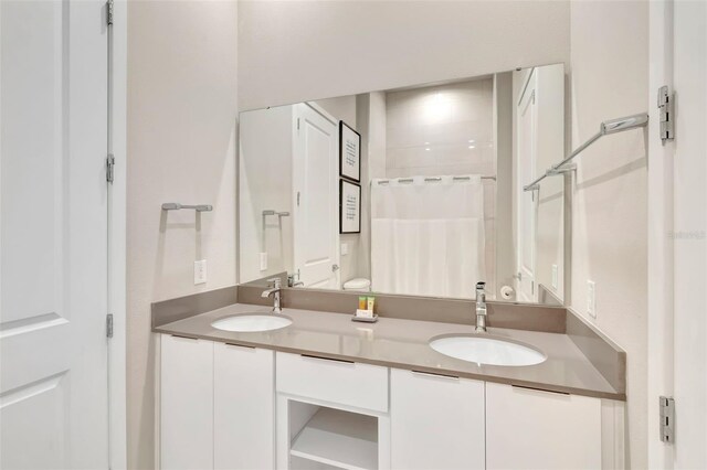 7740 Sandy Ridge Dr Unit 236, Reunion, FL 34747 - bathroom featuring double vanity, a sink, and a shower with shower curtain