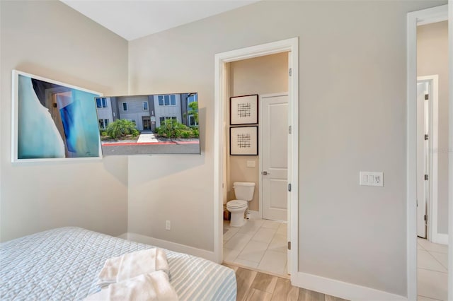 7740 Sandy Ridge Dr Unit 236, Reunion, FL 34747 - bedroom with ensuite bath and baseboards