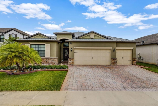 view of front of house with decorative driveway, stone siding, and stucco siding