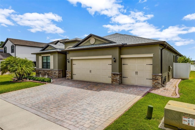 view of front of property with a garage, stucco siding, and stone siding