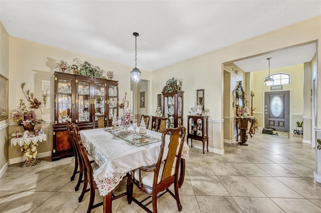 dining room with light tile patterned flooring and baseboards