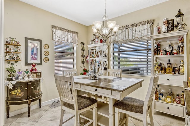 dining area featuring plenty of natural light, baseboards, light tile patterned flooring, and a chandelier