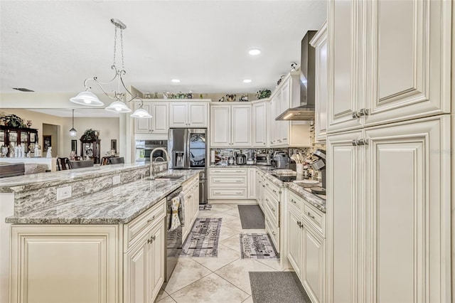 kitchen featuring light stone countertops, light tile patterned floors, a sink, appliances with stainless steel finishes, and backsplash