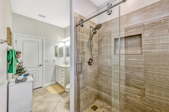 full bath featuring vanity, toilet, visible vents, and a stall shower