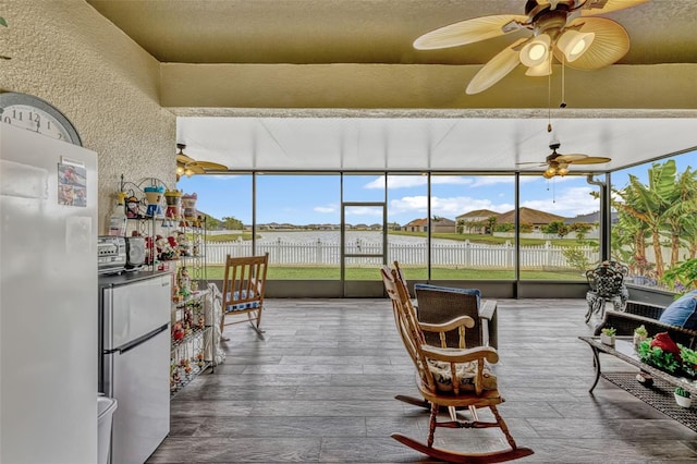 sunroom / solarium with a water view