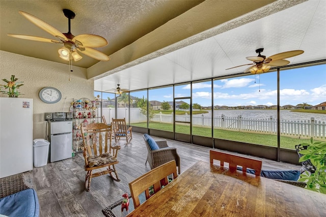 sunroom / solarium featuring a water view