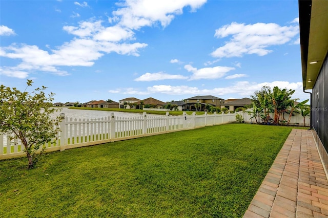 view of yard with a residential view and a fenced backyard