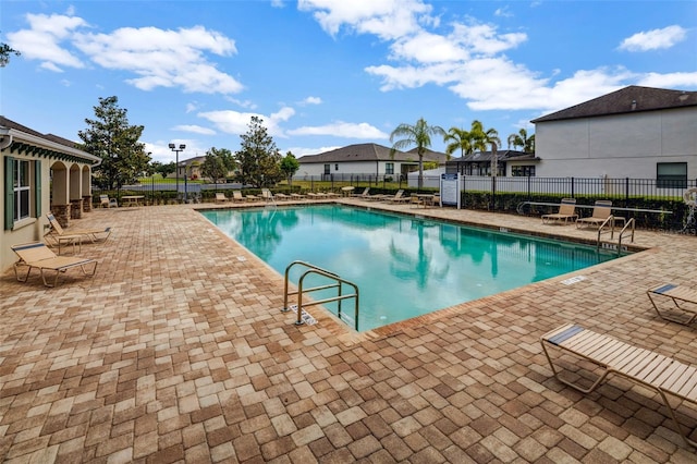 pool featuring a patio and fence