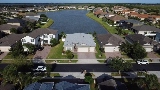 birds eye view of property with a water view and a residential view