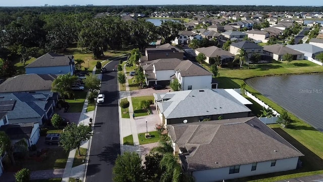 drone / aerial view with a residential view and a water view