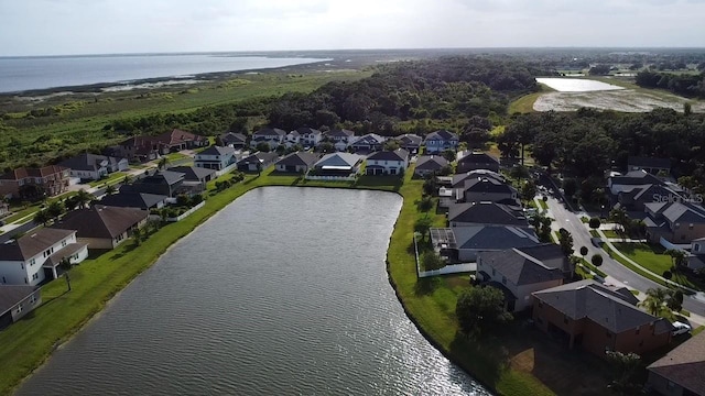 drone / aerial view with a residential view and a water view