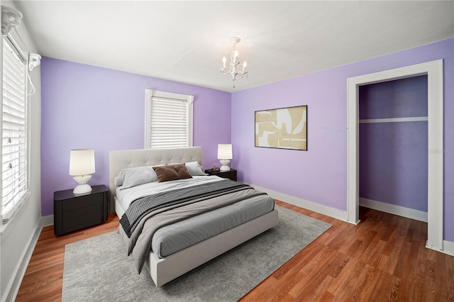 1400 Florida Ave, Saint Cloud, FL 34769 - bedroom featuring a chandelier, wood finished floors, and baseboards