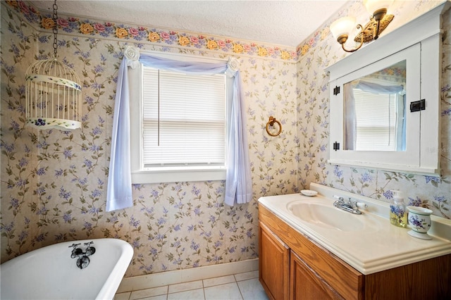1400 Florida Ave, Saint Cloud, FL 34769 - bathroom with a soaking tub, vanity, baseboards, tile patterned flooring, and a textured ceiling