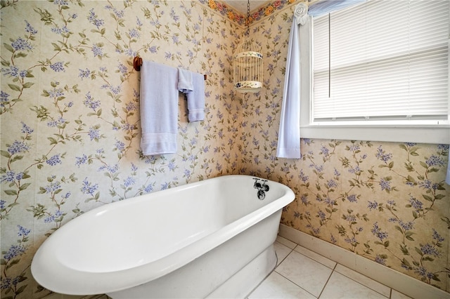 1400 Florida Ave, Saint Cloud, FL 34769 - full bath with baseboards, healthy amount of natural light, a soaking tub, wallpapered walls, and tile patterned flooring