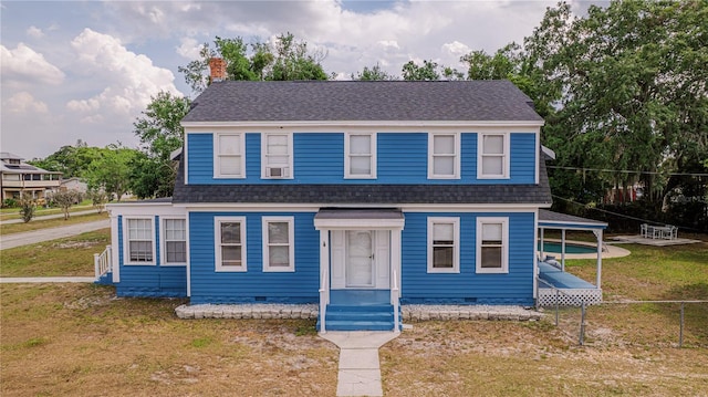 1400 Florida Ave, Saint Cloud, FL 34769 - view of front of property with crawl space, a shingled roof, and a chimney