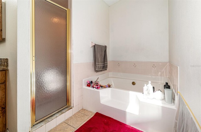 1100 Anne Elisa Cir, Saint Cloud, FL 34772 - full bath featuring tile patterned flooring, a shower stall, and a garden tub