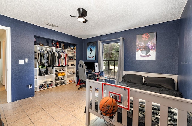 1100 Anne Elisa Cir, Saint Cloud, FL 34772 - bedroom with visible vents, a closet, a textured wall, a textured ceiling, and tile patterned floors