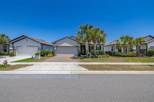 ranch-style home with an attached garage, concrete driveway, stucco siding, and a front yard