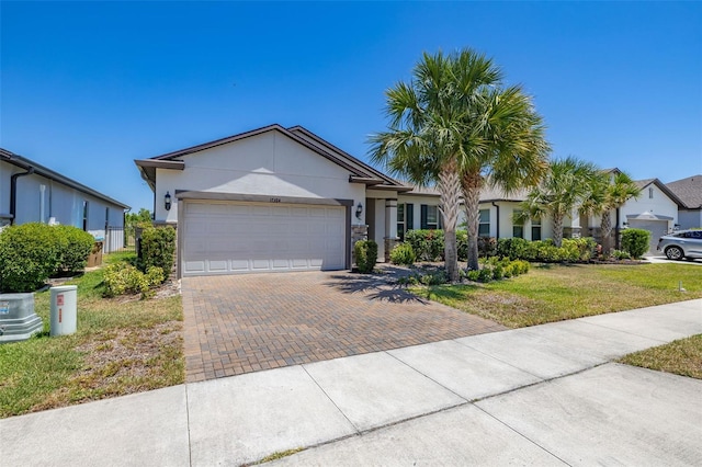 single story home with a garage, stucco siding, decorative driveway, and a front yard