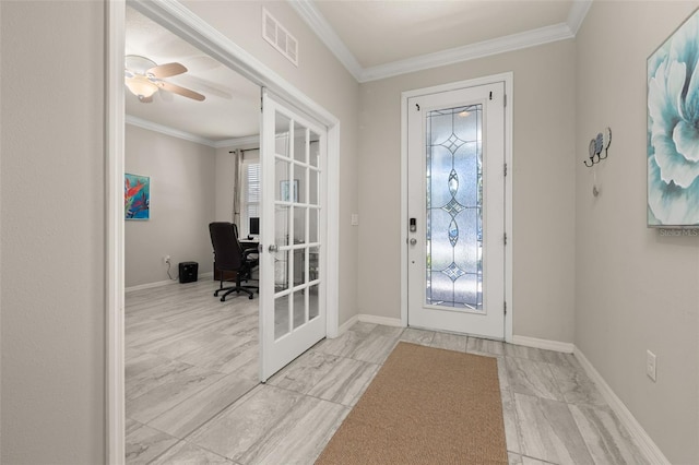 foyer entrance featuring crown molding, visible vents, and plenty of natural light