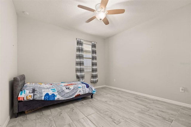 bedroom featuring baseboards and a ceiling fan