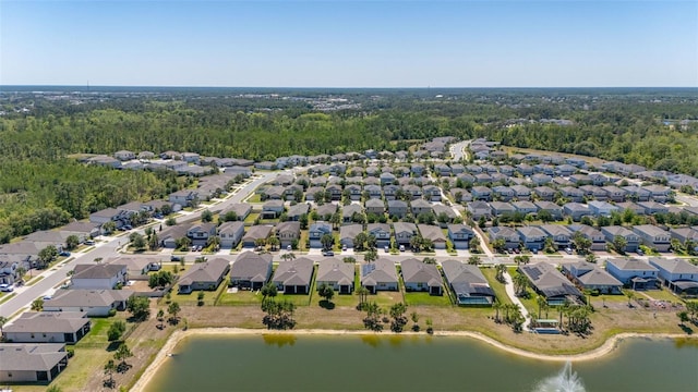 birds eye view of property with a residential view, a water view, and a wooded view