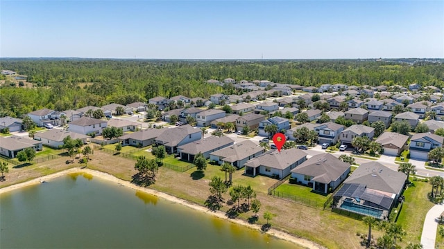 aerial view with a water view, a residential view, and a forest view