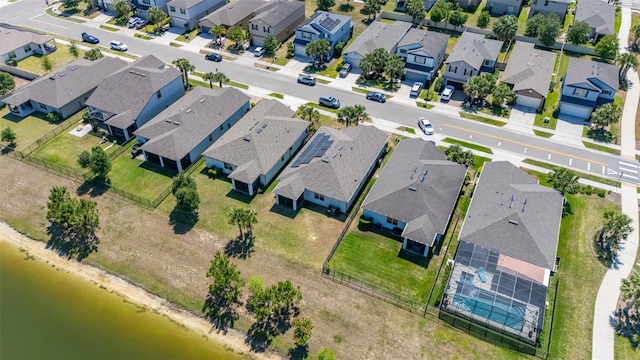 birds eye view of property with a residential view and a water view