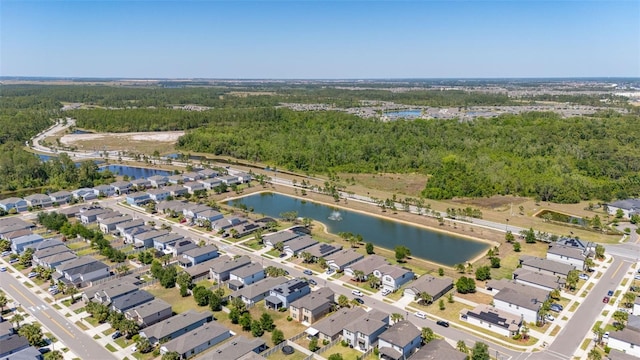 bird's eye view featuring a view of trees and a water view