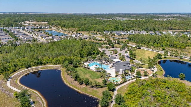 birds eye view of property featuring a water view and a forest view