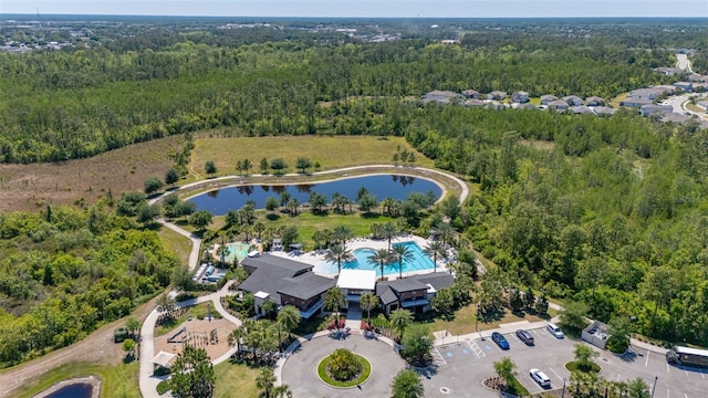aerial view with a water view and a wooded view