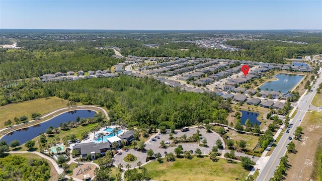 bird's eye view featuring a water view and a wooded view