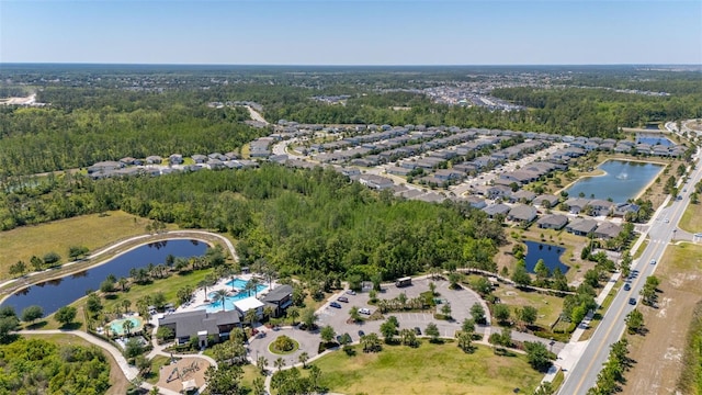 birds eye view of property with a water view and a forest view